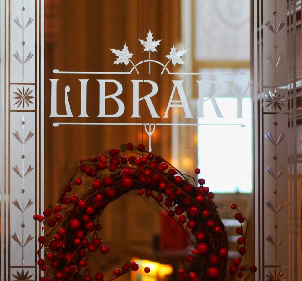 Photo of a library door with holiday decor. 